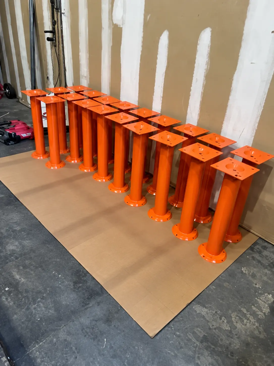 Glossy Orange Steel Supports in Workshop